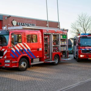Fire trucks parked outside Varsselveld fire station on a clear day.